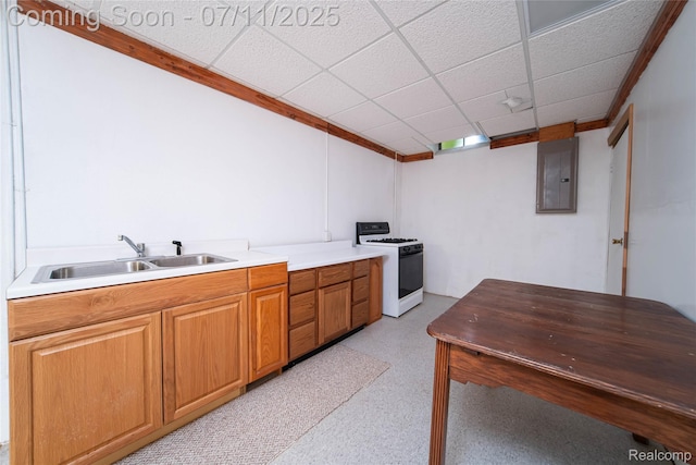 24145 Windridge Ln, Novi, MI 48374 - kitchen featuring white gas range oven, electric panel, a paneled ceiling, light countertops, and brown cabinets