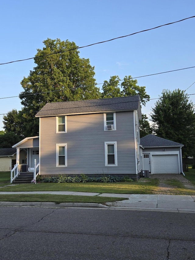 7 Hewitt St, Quincy, MI 49082 - view of front of house featuring a front lawn, a porch, driveway, and cooling unit