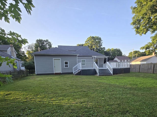 7 Hewitt St, Quincy, MI 49082 - rear view of house featuring a fenced backyard, a wooden deck, and roof with shingles