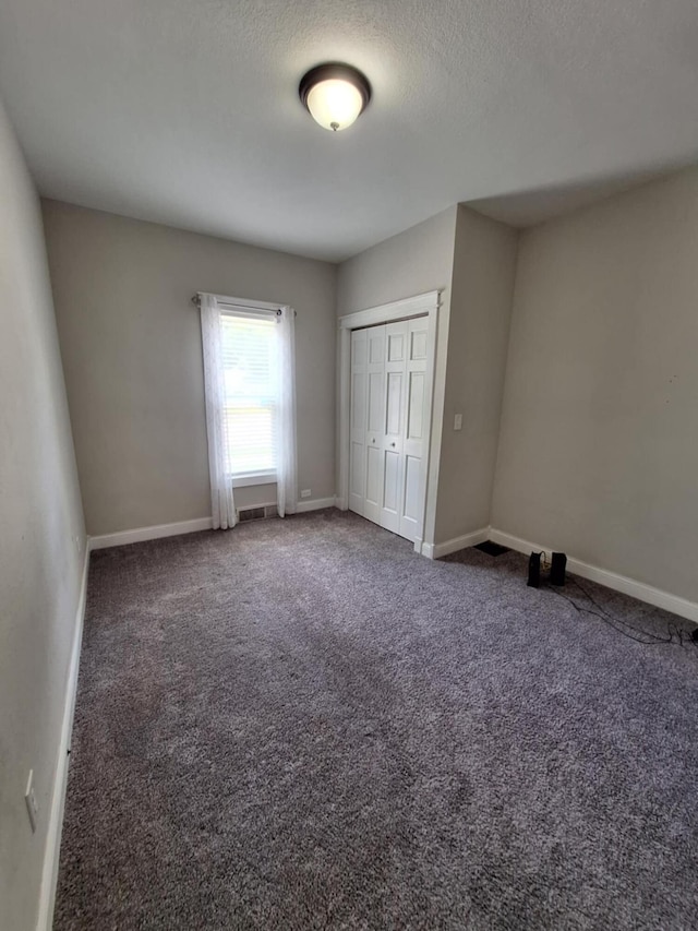7 Hewitt St, Quincy, MI 49082 - unfurnished bedroom featuring carpet floors, a closet, and a textured ceiling