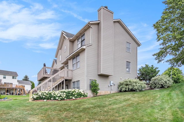5665 Koster Dr SW, Wyoming, MI 49418 - view of property exterior featuring a chimney, a lawn, and a deck