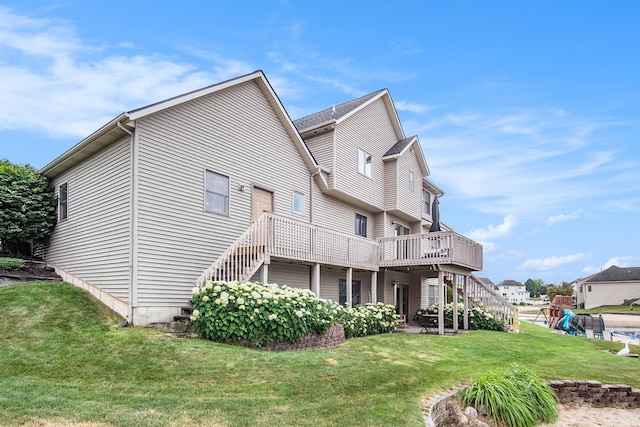5665 Koster Dr SW, Wyoming, MI 49418 - back of house featuring stairway, a wooden deck, a lawn, and a patio
