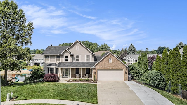 5665 Koster Dr SW, Wyoming, MI 49418 - traditional home featuring a porch, driveway, an attached garage, brick siding, and a shingled roof