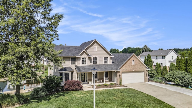 5665 Koster Dr SW, Wyoming, MI 49418 - traditional home with covered porch, driveway, a garage, a front yard, and a shingled roof