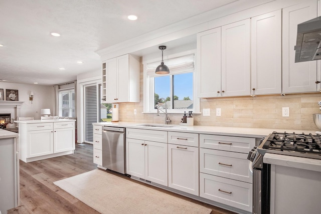 5665 Koster Dr SW, Wyoming, MI 49418 - kitchen featuring appliances with stainless steel finishes, recessed lighting, tasteful backsplash, white cabinets, and light countertops