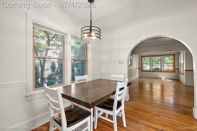 524 Oakland Ave, Birmingham, MI 48009 - dining space featuring arched walkways, a chandelier, and wood finished floors