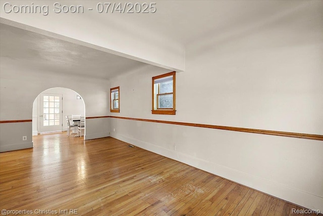 524 Oakland Ave, Birmingham, MI 48009 - spare room featuring arched walkways and light wood finished floors
