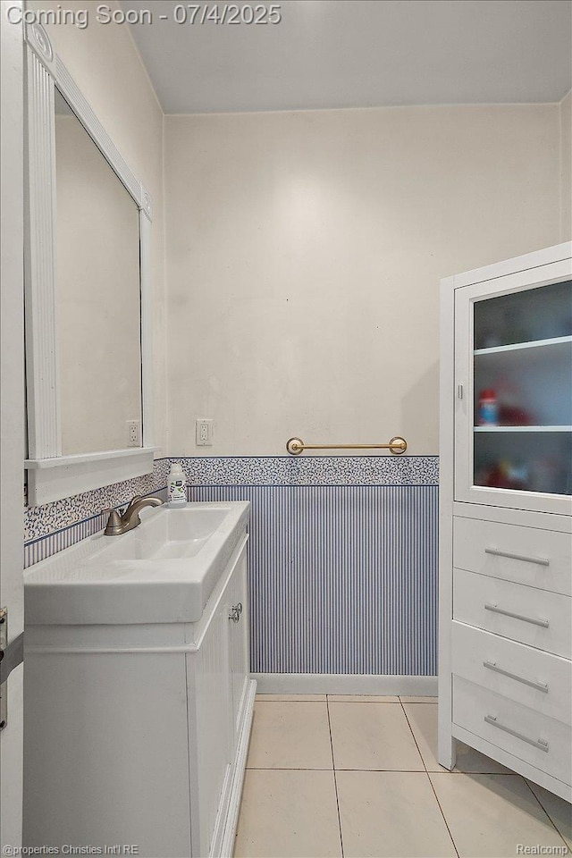 524 Oakland Ave, Birmingham, MI 48009 - bathroom featuring vanity, a wainscoted wall, and tile patterned flooring