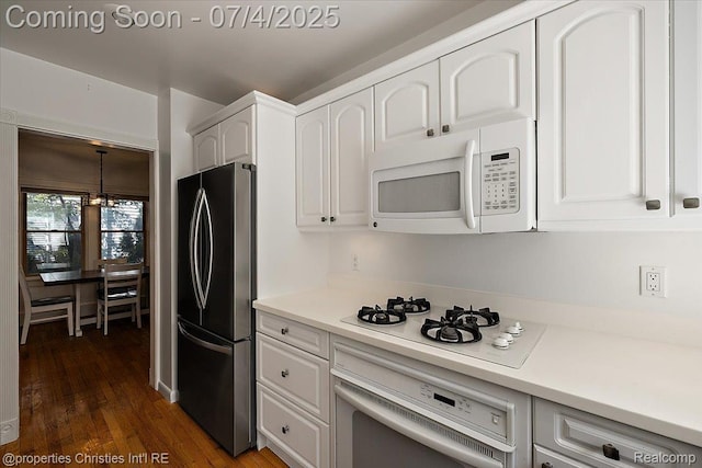 524 Oakland Ave, Birmingham, MI 48009 - kitchen with white appliances, white cabinets, dark wood-style floors, and a chandelier