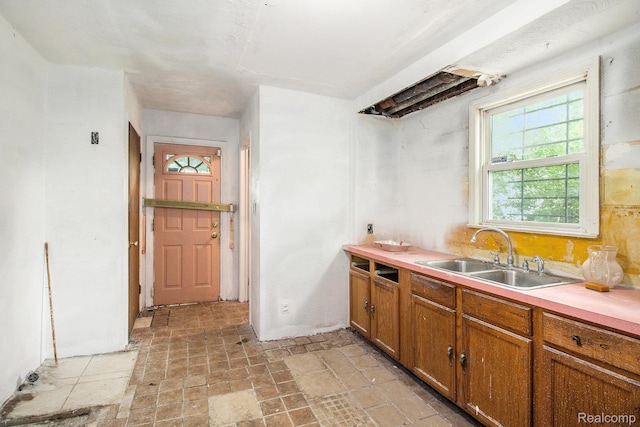 1612 Euclid Ave, Flint, MI 48503 - kitchen featuring brown cabinets, light countertops, and light stone finish floors