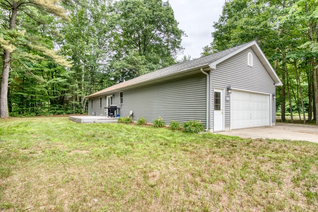 19085 Joslin Cir, Big Rapids, MI 49307 - view of side of property with a lawn, a garage, and a shingled roof