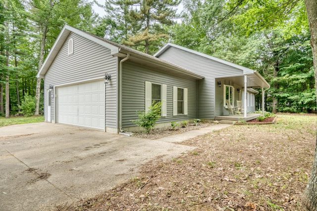 19085 Joslin Cir, Big Rapids, MI 49307 - view of front of property featuring a garage, concrete driveway, and a porch