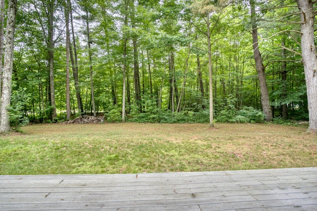 19085 Joslin Cir, Big Rapids, MI 49307 - view of yard featuring a wooden deck and a wooded view
