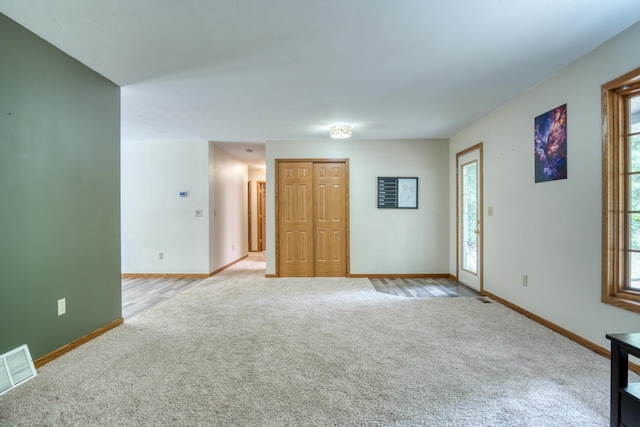 19085 Joslin Cir, Big Rapids, MI 49307 - unfurnished living room featuring light colored carpet and plenty of natural light