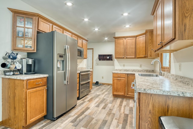 19085 Joslin Cir, Big Rapids, MI 49307 - kitchen with appliances with stainless steel finishes, light wood finished floors, brown cabinetry, recessed lighting, and light countertops