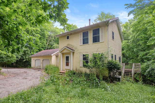 7906 N 43rd St, Augusta, MI 49012 - view of front facade with a wooden deck and stairway