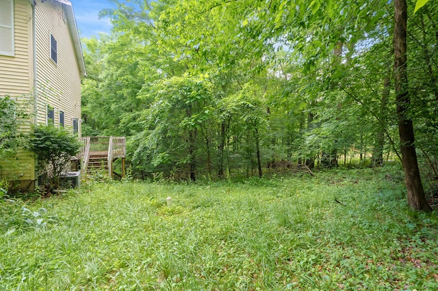 7906 N 43rd St, Augusta, MI 49012 - view of yard with a wooden deck, stairway, and a view of trees
