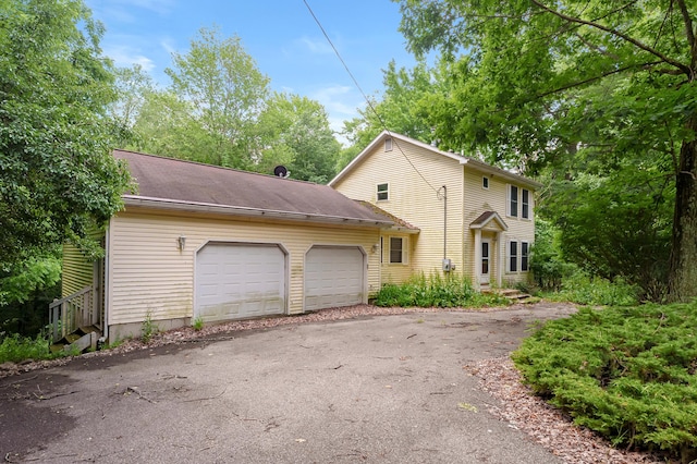 7906 N 43rd St, Augusta, MI 49012 - view of front facade featuring a garage and driveway