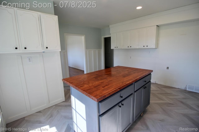 4201 N Burkhart Rd, Howell, MI 48855 - kitchen featuring butcher block counters, white cabinetry, recessed lighting, gray cabinets, and a center island