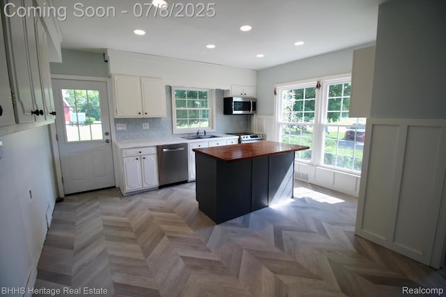 4201 N Burkhart Rd, Howell, MI 48855 - kitchen featuring appliances with stainless steel finishes, butcher block countertops, white cabinets, a wainscoted wall, and recessed lighting
