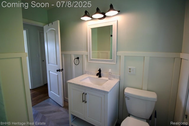 4201 N Burkhart Rd, Howell, MI 48855 - half bath featuring vanity and a wainscoted wall