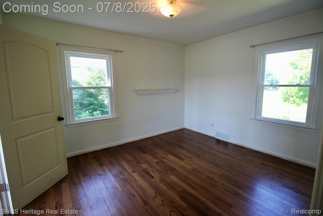 4201 N Burkhart Rd, Howell, MI 48855 - empty room featuring dark wood-style flooring and baseboards
