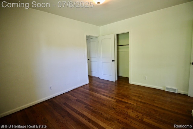 4201 N Burkhart Rd, Howell, MI 48855 - unfurnished bedroom featuring dark wood-style floors and a closet