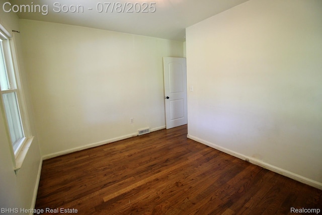 4201 N Burkhart Rd, Howell, MI 48855 - unfurnished room with dark wood finished floors and baseboards