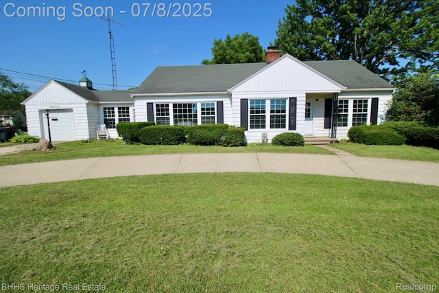 4201 N Burkhart Rd, Howell, MI 48855 - view of front of property with a chimney, a front lawn, a garage, and roof with shingles