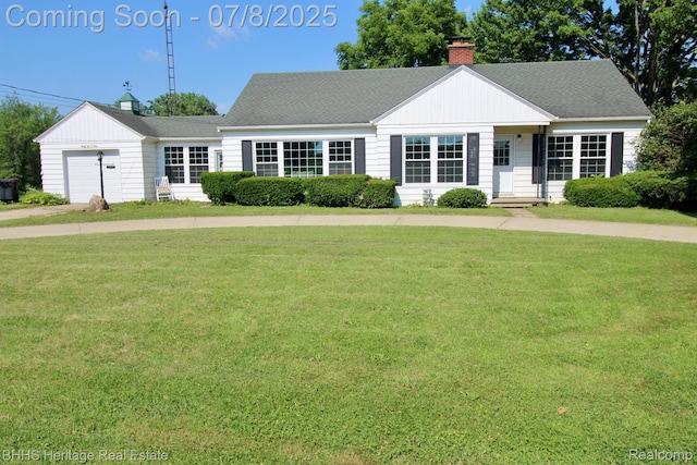 4201 N Burkhart Rd, Howell, MI 48855 - view of front of property with a chimney, a front yard, a garage, and a shingled roof