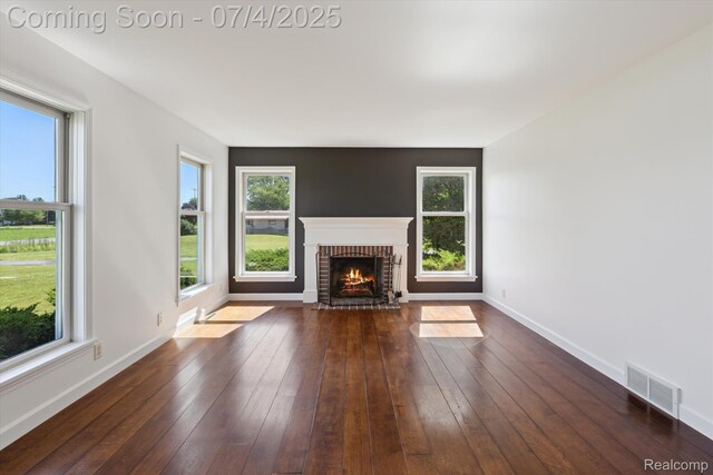 10934 Baker Rd, Frankenmuth, MI 48734 - unfurnished living room with a fireplace, healthy amount of natural light, and wood-type flooring