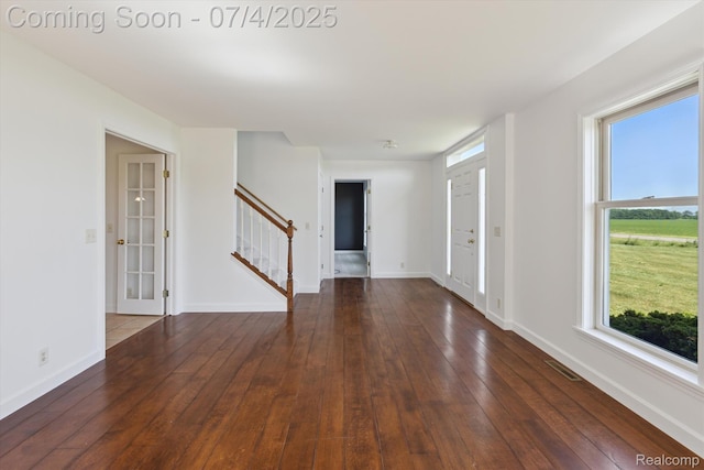 10934 Baker Rd, Frankenmuth, MI 48734 - empty room with stairway, hardwood / wood-style flooring, and healthy amount of natural light