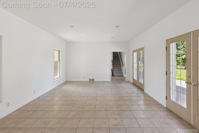 10934 Baker Rd, Frankenmuth, MI 48734 - unfurnished room featuring light tile patterned floors, stairway, and french doors