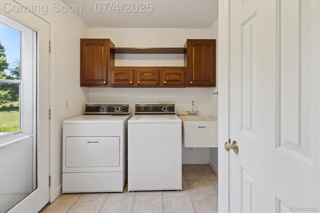 10934 Baker Rd, Frankenmuth, MI 48734 - laundry area with cabinet space, washer and dryer, and light tile patterned flooring