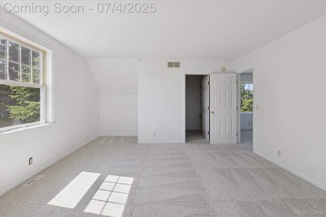 10934 Baker Rd, Frankenmuth, MI 48734 - unfurnished bedroom featuring a spacious closet, carpet flooring, and lofted ceiling