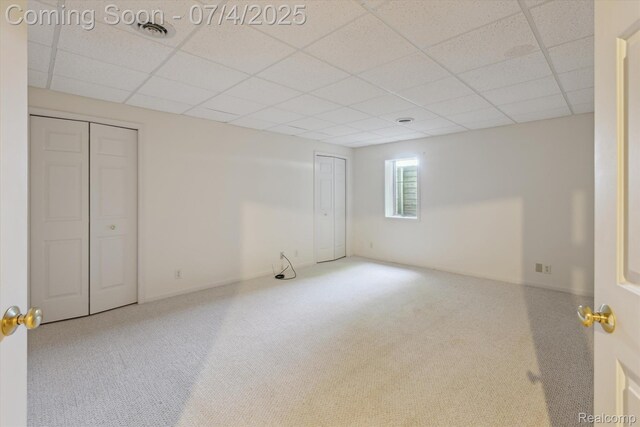 10934 Baker Rd, Frankenmuth, MI 48734 - unfurnished bedroom with carpet floors, a drop ceiling, and two closets