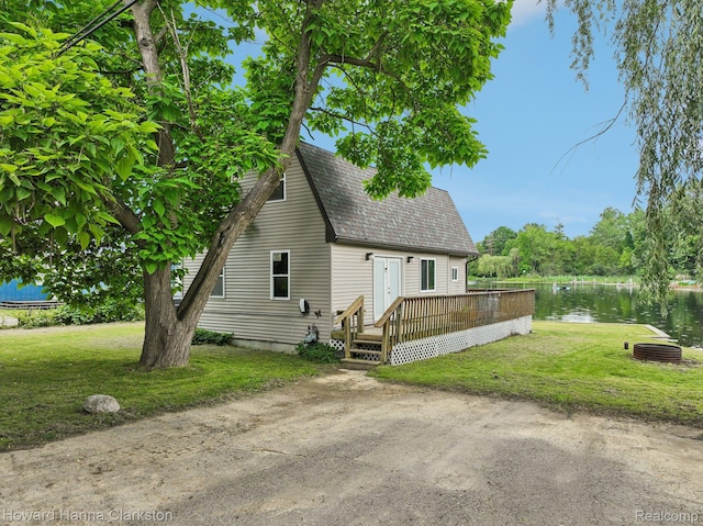 6830 Dixie Hwy, Clarkston, MI 48346 - view of front of home with a shingled roof, a front yard, and a deck with water view