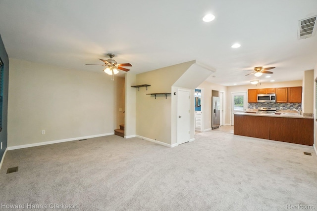 6830 Dixie Hwy, Clarkston, MI 48346 - unfurnished living room featuring ceiling fan, recessed lighting, light carpet, and stairway
