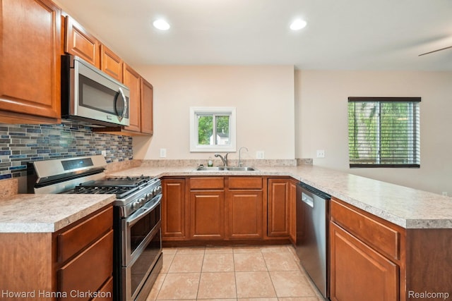 6830 Dixie Hwy, Clarkston, MI 48346 - kitchen with appliances with stainless steel finishes, a peninsula, light countertops, brown cabinetry, and recessed lighting