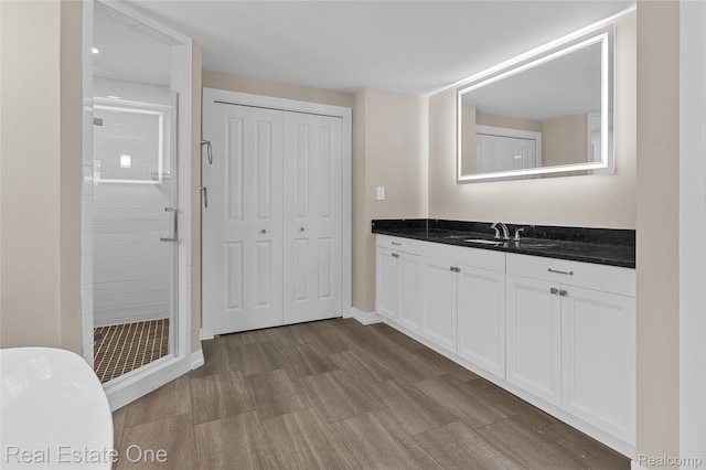 1746 N Lafayette St, Dearborn, MI 48128 - bathroom with a shower stall, vanity, wood finished floors, and a soaking tub