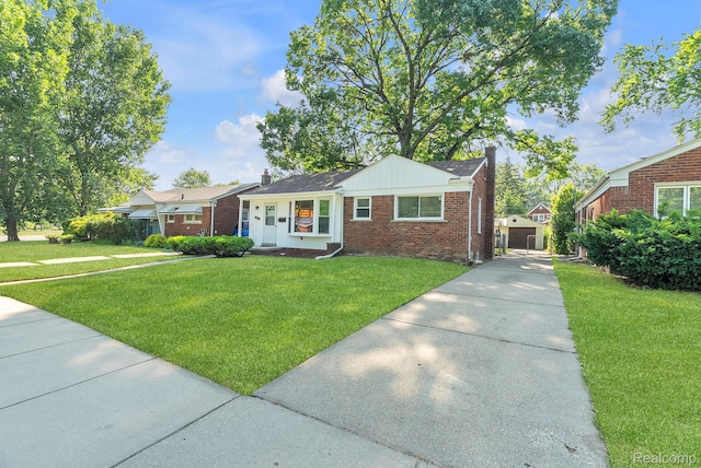 1885 Pelham St, Dearborn, MI 48124 - ranch-style home with a chimney, brick siding, a front lawn, and concrete driveway