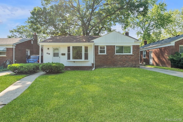 1885 Pelham St, Dearborn, MI 48124 - view of front facade with a front lawn, brick siding, and a chimney