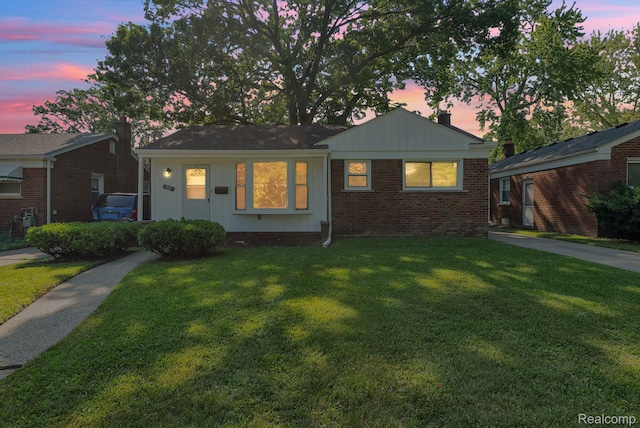 1885 Pelham St, Dearborn, MI 48124 - view of front of house featuring a lawn, brick siding, and a chimney