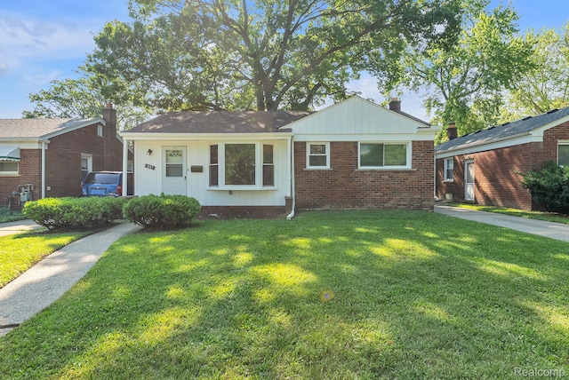 1885 Pelham St, Dearborn, MI 48124 - view of front of house featuring a front lawn, brick siding, and a chimney