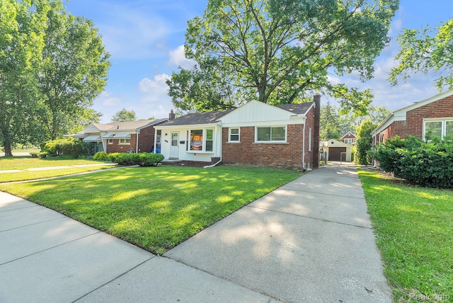 1885 Pelham St, Dearborn, MI 48124 - ranch-style home featuring brick siding, a chimney, a front lawn, and driveway