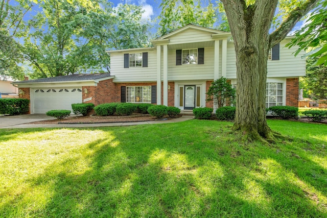 29947 Fernhill Dr, Farmington, MI 48331 - view of front of property with brick siding, a garage, a front yard, and driveway