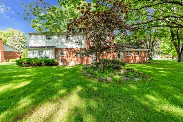29947 Fernhill Dr, Farmington, MI 48331 - back of house featuring brick siding and a lawn