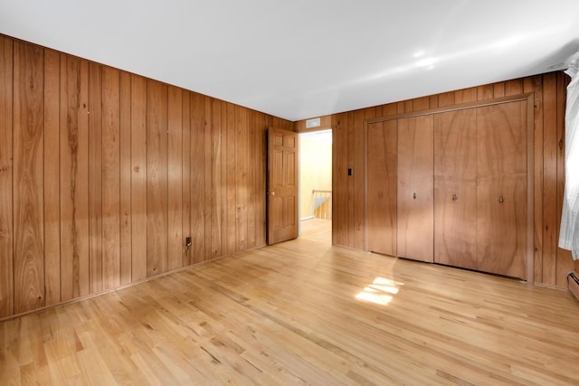 29947 Fernhill Dr, Farmington, MI 48331 - unfurnished bedroom featuring wood walls, wood finished floors, and a closet