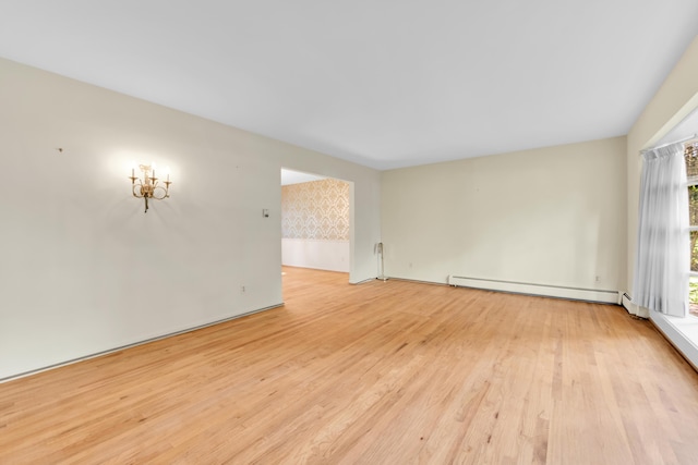 29947 Fernhill Dr, Farmington, MI 48331 - empty room with a baseboard heating unit and light wood finished floors