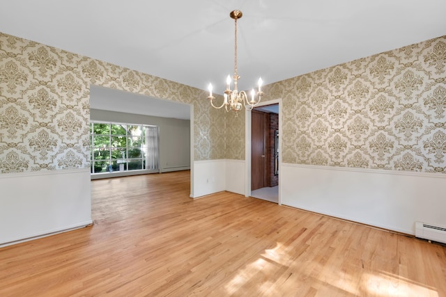 29947 Fernhill Dr, Farmington, MI 48331 - unfurnished room featuring a wainscoted wall, a chandelier, wood finished floors, wallpapered walls, and a baseboard heating unit
